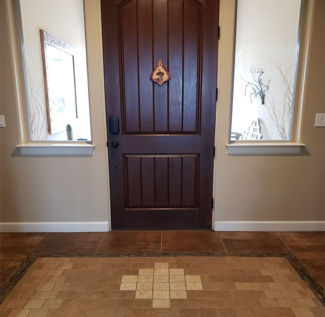 A door with a wooden frame and a rug on the floor.