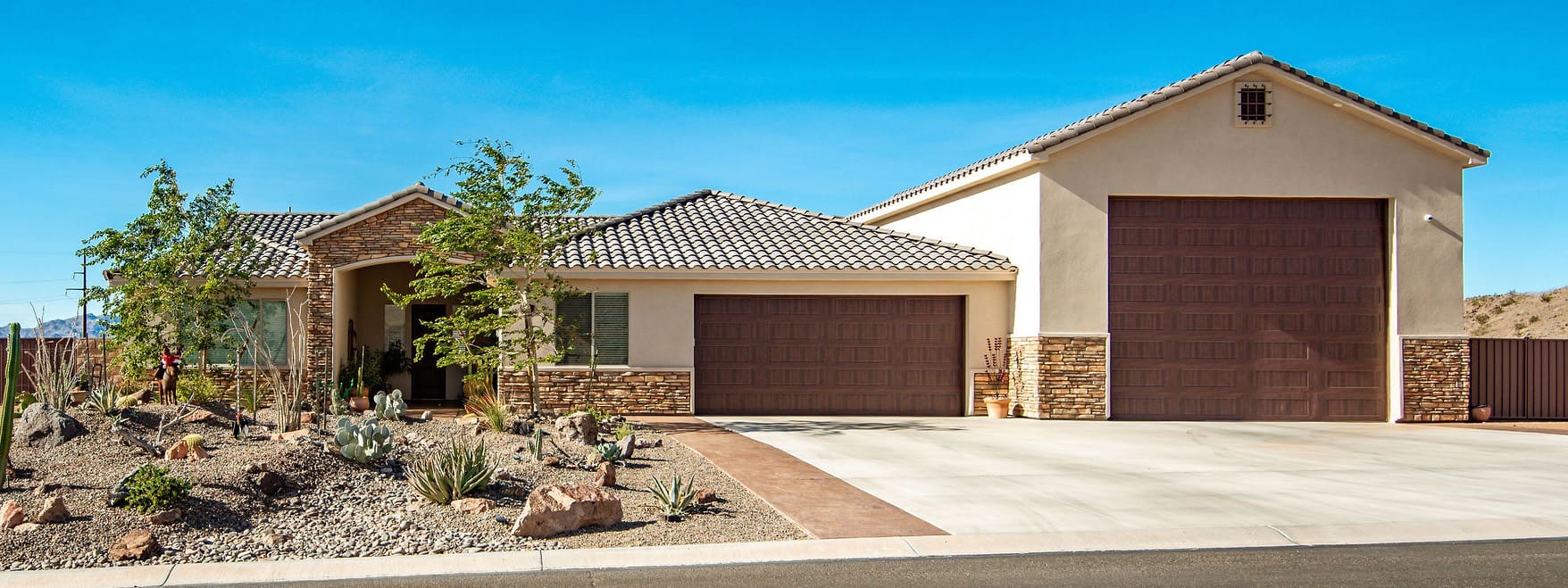 A brown garage door sitting in front of a house.