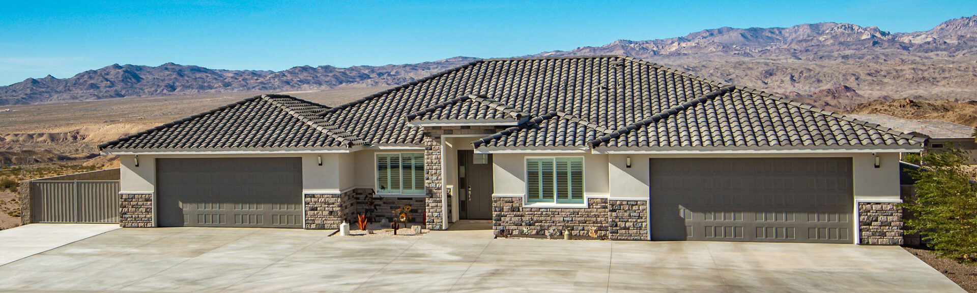 A house with a tile roof and stone trim.