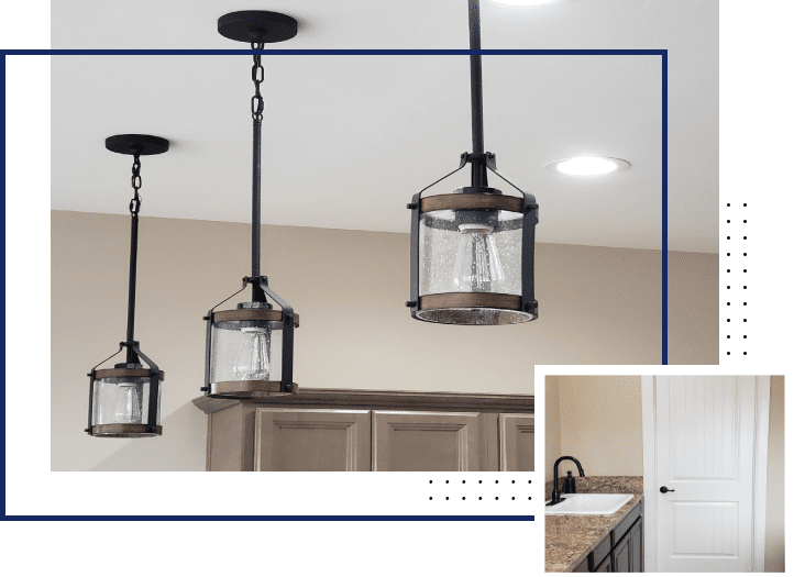 A kitchen with three lights hanging from the ceiling.